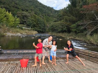 鮎つかみ取り体験する家族