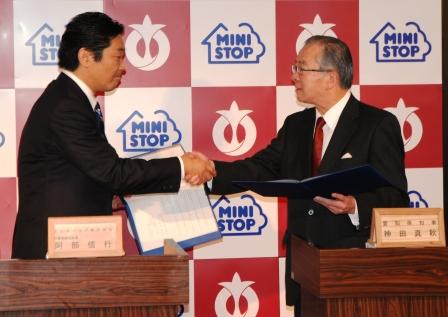 (協定を締結し握手する阿部社長・神田知事)